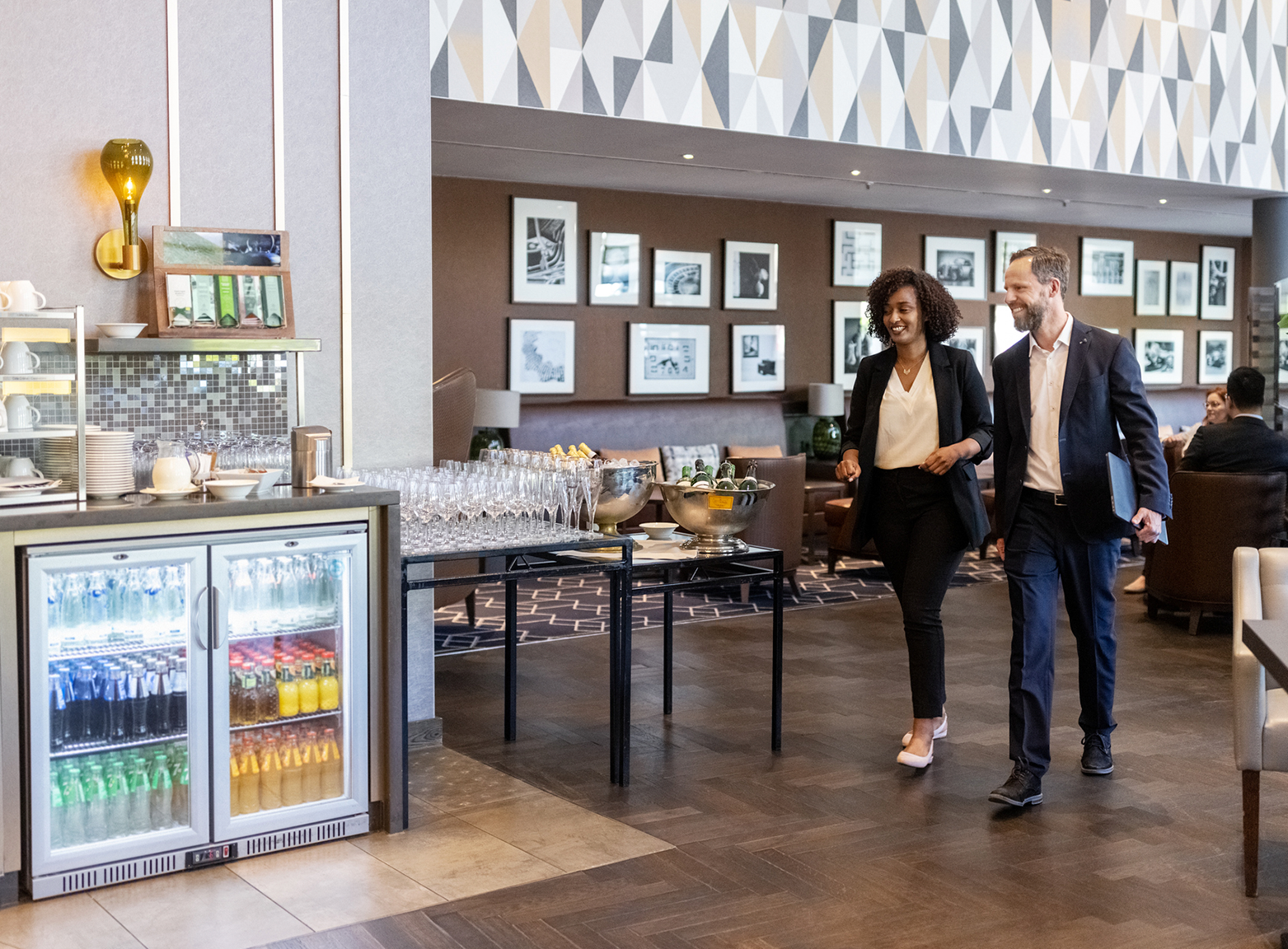 Hombre junto a mujer caminado en el desayunador de un hotel