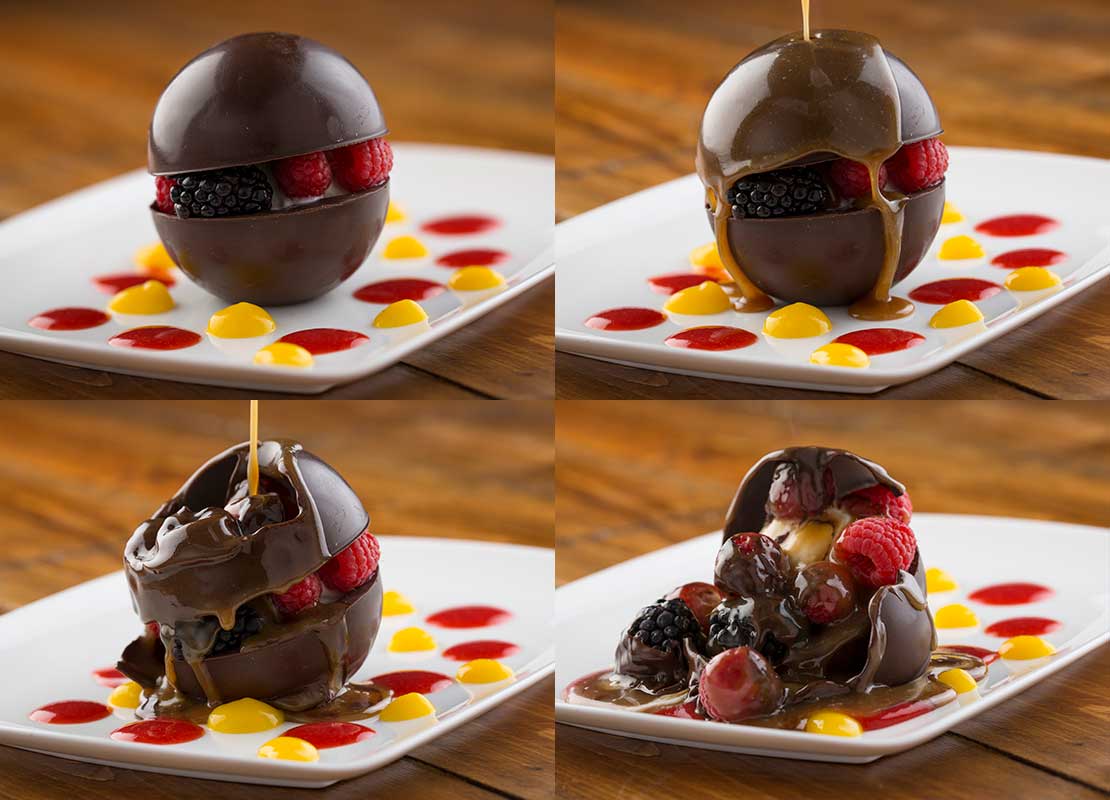 Secuencia de un postre esférico de chocolate relleno de frutas, que se derrite al verter salsa caliente
