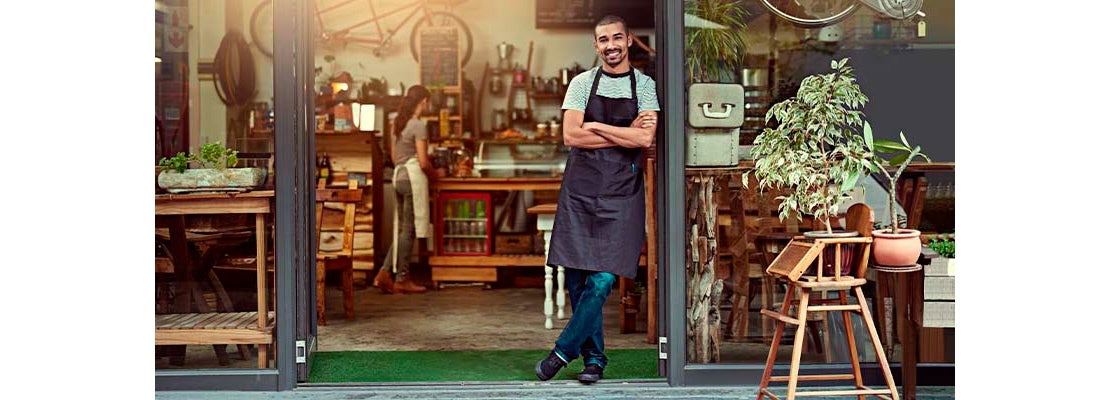 Hombre dando la bienvenida a su cafetería