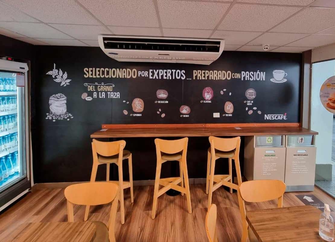 Banner sobre la producción del café de NESCAFÉ® instalado en una cafetería de una estación Shell