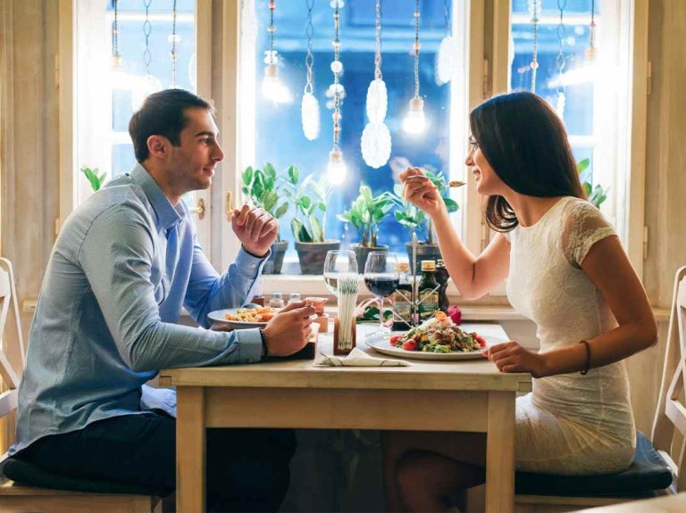 Iluminación para restaurante cálida en terraza con mesa de madera vacía para producto.