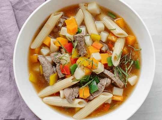 Plato con Minestrone elaborado con pasta, carne, vegetales y productos MAGGI®