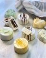 7 Alfajores de galleta con Manjar NESTLÉ® decorados de forma diferente sobre una mesa