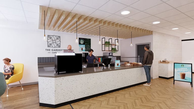 Barra de cafetería con atención al cliente y operación profesional de café